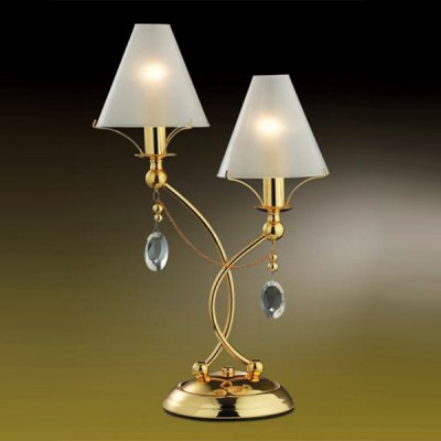 Настольная лампа Odeon light 2121/2T Lino золото Настольная лампа Odeon light 2121/2T Lino золотоС абажуром<br>Элегантная и изящная, эта настольная лампа привлекает к себе внимание безупречным видом. Наличие двух плафонов позволяет освещать одновременно несколько зон, при этом нет необходимости покупать дополнительные источники света. Подвески из крупного хрусталя смотрятся изысканно и роскошно. Плафоны-абажуры создают мягкое, комфортное для глаз, освещение. Благородное сочетание золотого и белого цветов делают эту лампу заметной для всех, кто зайдет в комнату, где она находится.<br><br>S освещ. до, м2: 5<br>Тип товара: настольная лампа<br>Скидка, %: 21<br>Тип лампы: накал-я - энергосбер-я<br>Тип цоколя: E14<br>Количество ламп: 2<br>MAX мощность ламп, Вт: 40<br>Диаметр, мм мм: 280<br>Высота, мм: 460<br>Цвет арматуры: золотой