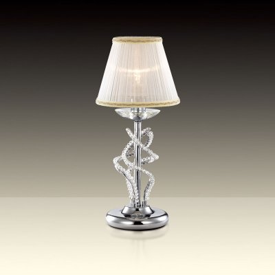 Светильник настольный Odeon light 2611/1T Светильник настольный Odeon light 2611/1TКлассические<br>Настольная лампа – это не просто источник дополнительного освещения, но и оригинальный элемент декора. Его можно установить в спальне, гостиной, кабинете и других комнатах. Интернет-магазин «Светодом» предлагает настольные лампы разных стилей по доступным ценам. Благодаря большому ассортименту Вы обязательно найдете в нашем каталоге именно ту модель, которую искали. Настольная лампа Odeon light 2611/1T – прекрасный вариант для завершения интерьера. Ее можно включить одновременно с люстрой для более яркого освещения или без нее для создания уютной атмосферы, настраивающей на отдых. Купить настольную лампу Odeon light 2611/1T Вы можете с помощью виртуальной «Корзины» или по контактным номерам, указанным на сайте.<br><br>S освещ. до, м2: 4<br>Тип цоколя: E27<br>Количество ламп: 1<br>Ширина, мм: 180<br>MAX мощность ламп, Вт: 60<br>Высота, мм: 400<br>Оттенок (цвет): абажур<br>Цвет арматуры: серебристый