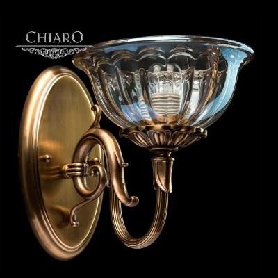 Светильник настенный бра Chiaro 411021001 Паула Светильник настенный бра Chiaro 411021001 ПаулаКлассика<br>Описание модели 411021001: Роскошь в светильнике из коллекции Паула присутствует в каждой детали, прежде всего, благодаря использованию первоклассных материалов. Бра полностью выполнена из благородной латуни. Изогнутый рожок направлен вверх, тонированный плафон с рельефной поверхностью мягко рассеивают свет. Центральная ось светильника из коллекции Паула выполнена из нескольких фигурных элементов.<br><br>S освещ. до, м2: 3<br>Тип лампы: накаливания / энергосберегающая / светодиодная<br>Тип цоколя: E14<br>Количество ламп: 1<br>Ширина, мм: 200<br>MAX мощность ламп, Вт: 40<br>Длина, мм: 230<br>Высота, мм: 280<br>Поверхность арматуры: матовый<br>Цвет арматуры: бронзовый