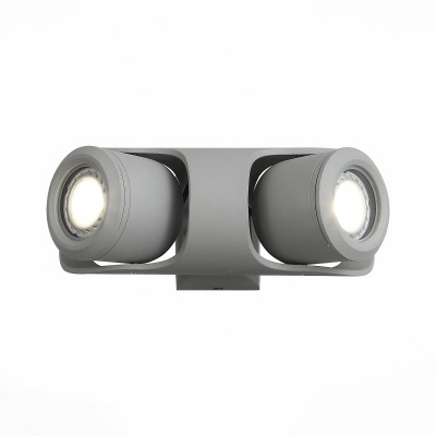 Уличный настенный светильник St luce SL093.701.02 Уличный настенный светильник St luce SL093.701.02Настенные<br>Стильные миниатюрные светильники коллекции Round украсят и дополнят обстановку экстерьера загородного дома. Их основание выполнены из металла и окрашены в два варианта цвета: серый и черный. Галогеновая лампа закрыта плафоном из прочного стекла. Точная цилиндрическая форма, идеальная для уличных светильников цветовая гамма, качественные материалы – неоспоримые достоинства этой коллекции. Помимо того, светильники имеют высокий уровень IP защиты от влаги и пыли. Они идеальны для зональной подсветки газонов, дорожек, крыльца и ступеней.<br><br>Крепление: планка<br>Цветовая t, К: 4000<br>Тип лампы: галогенная/LED<br>Тип цоколя: G5.3<br>Цвет арматуры: серый<br>Количество ламп: 2<br>Ширина, мм: 235<br>Длина, мм: 90<br>Расстояние от стены, мм: 130<br>Поверхность арматуры: матовая<br>Оттенок (цвет): коричневый<br>MAX мощность ламп, Вт: 60